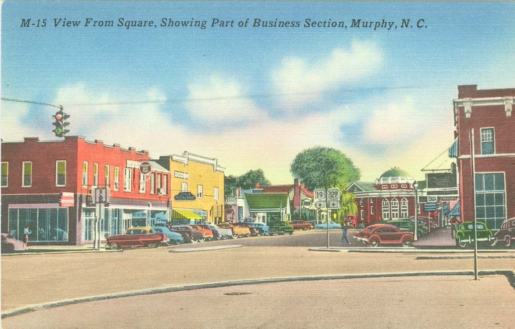 Downtown Murphy NC postcard with courthouse in background right. Note US129 sign.